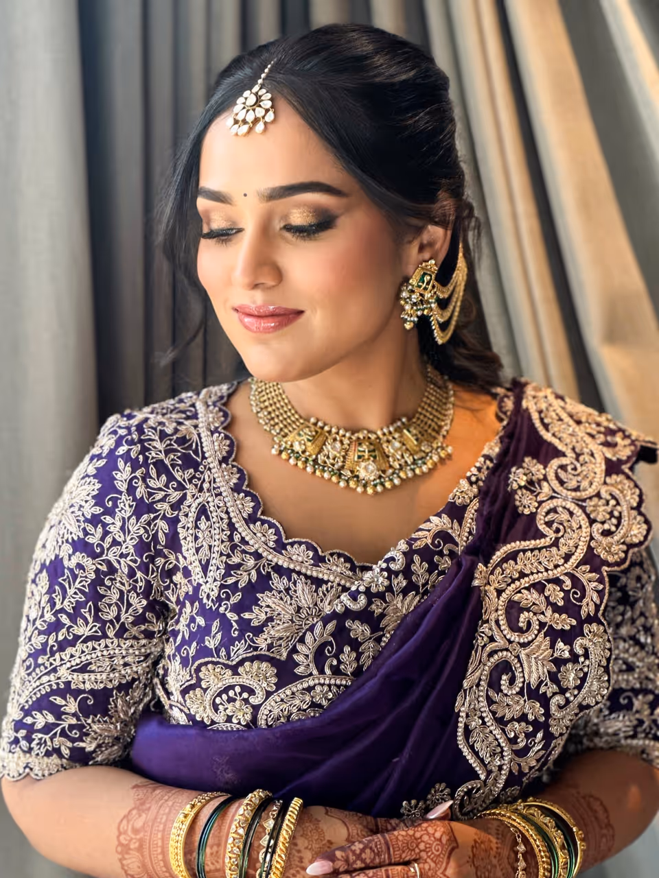 Classic Indian bridal look with radiant skin and a red lip