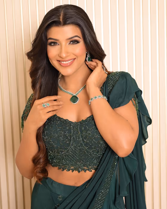 Emerald lehenga with sleek hair and a defined eye