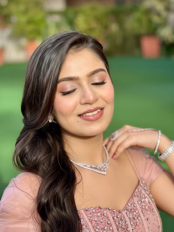 Blush pink gown with soft waves and a luminous base
