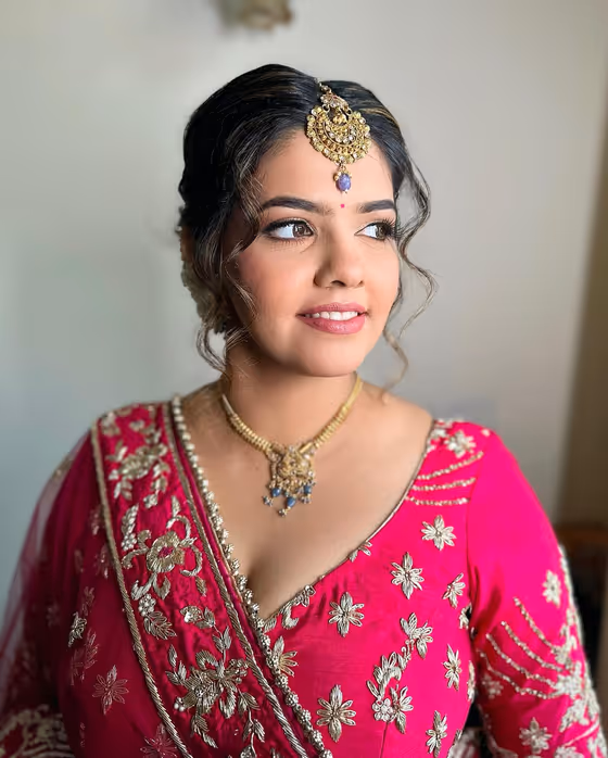 Bright pink lehenga with a warm base and defined brows