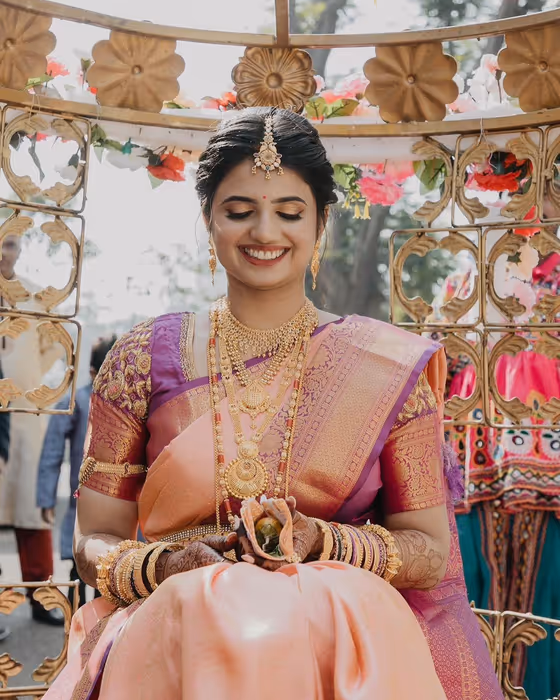 South Indian bride in a pink kanjeevaram with temple jewellery