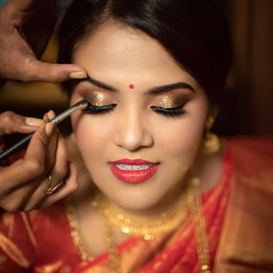 Close-up of a gold smoky eye being lined on a bride